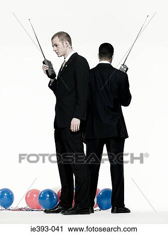 Stock Image - Men with walkie talkies. Fotosearch