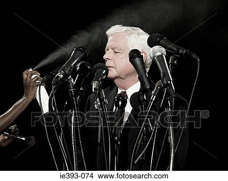 Picture - Politician being sprayed with hairspray. Fotosearch