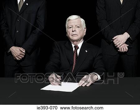 Stock Image - Politician signing paper. Fotosearch