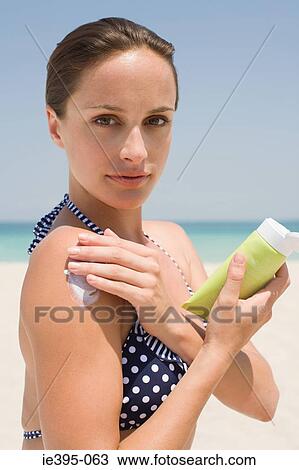 A woman applying suncream View Large Photo Image Stock Image - A woman applying suncream. Fotosearch