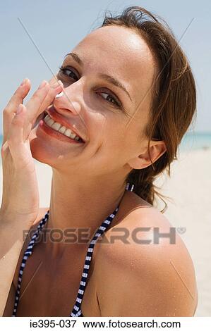 A woman applying suncream View Large Photo Image Stock Photo - A woman applying suncream. Fotosearch