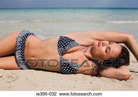 A woman sunbathing View Large Photo Image Stock Image - A woman sunbathing. Fotosearch