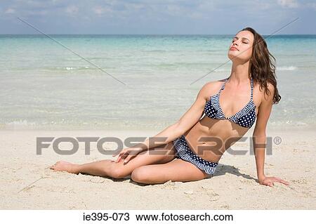 A woman sunbathing View Large Photo Image Stock Image - A woman sunbathing. Fotosearch