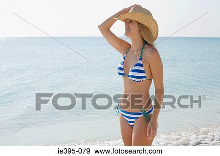 Stock Photo - A woman wearing a sun hat. Fotosearch