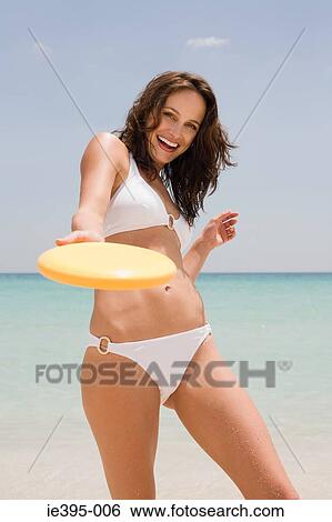 A young woman holding a flying disc View Large Photo Image Stock Photograph - A young woman holding a flying disc. Fotosearch