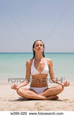 A young woman meditating View Large Photo Image Stock Image - A young woman meditating. Fotosearch