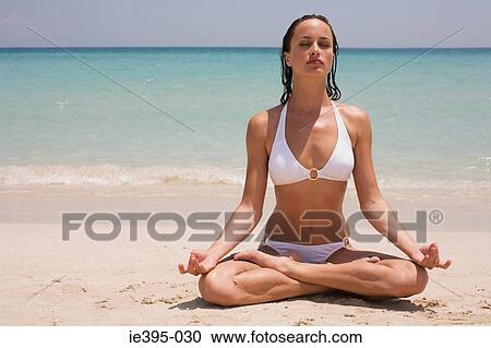 Stock Image - A young woman meditating. Fotosearch