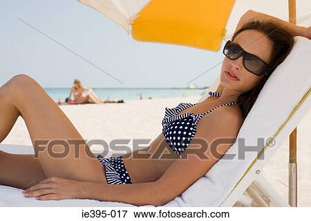 Portrait of a woman on a lounge chair View Large Photo Image Stock Photo - Portrait of a woman on a lounge chair. Fotosearch