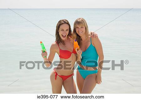 Portrait of friends holding waterpistols View Large Photo Image Stock Photo - Portrait of friends holding waterpistols. Fotosearch