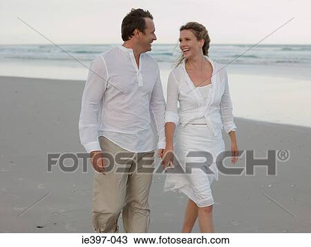 Couple walking on the beach View Large Photo Image Stock Image - Couple walking on the beach. Fotosearch