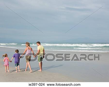 Picture - Family walking by the sea. Fotosearch