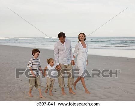 Family walking on the beach View Large Photo Image Stock Image - Family walking on the beach. Fotosearch