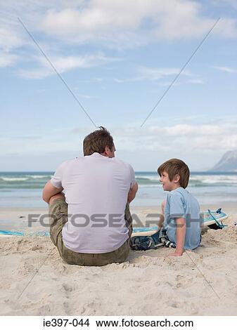 Father and son at the beach View Large Photo Image Picture - Father and son at the beach. Fotosearch