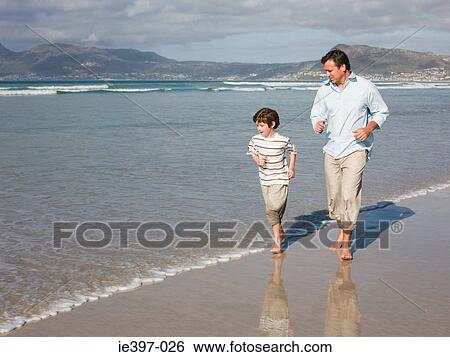 Father and son running by sea View Large Photo Image Stock Photograph - Father and son running by sea. Fotosearch