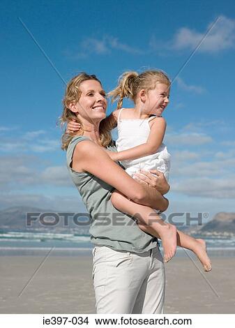 Mother holding daughter View Large Photo Image Picture - Mother holding daughter. Fotosearch