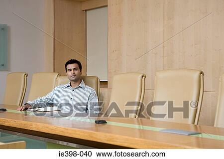 Businessman sitting in a conference room View Large Photo Image Stock Image - Businessman sitting in a conference room. Fotosearch