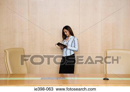 Stock Image - Businesswoman in a conference room. Fotosearch