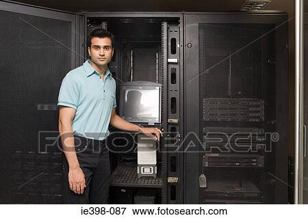 Computer technician working on a server View Large Photo Image Stock Photo - Computer technician working on a server. Fotosearch