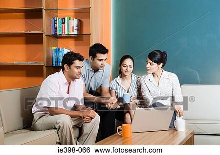 Stock Photograph - Four indian office colleagues. Fotosearch