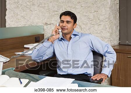 Indian businessman using the telephone View Large Photo Image Stock Photography - Indian businessman using the telephone. Fotosearch