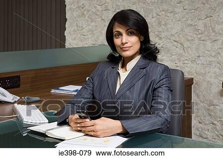 Indian businesswoman in office View Large Photo Image Stock Photo - Indian businesswoman in office. Fotosearch