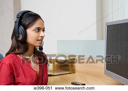 Indian woman working in a call centre View Large Photo Image Stock Image - Indian woman working in a call centre. Fotosearch