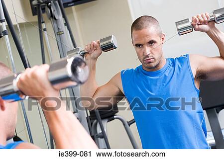 Man using dumbbells View Large Photo Image Stock Image - Man using dumbbells. Fotosearch