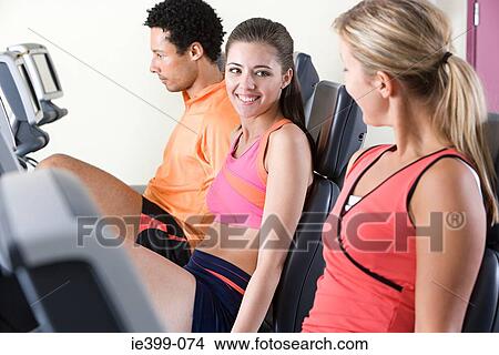 People on exercise bikes View Large Photo Image Picture - People on exercise bikes. Fotosearch