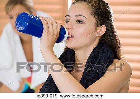 Woman drinking at gym View Large Photo Image Stock Photo - Woman drinking at gym. Fotosearch