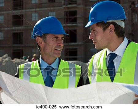 Stock Photography - Architects with blueprint. Fotosearch