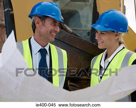 Stock Photography - Architects with blueprint. Fotosearch