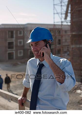 Engineer on cellphone View Large Photo Image Stock Image - Engineer on cellphone. Fotosearch