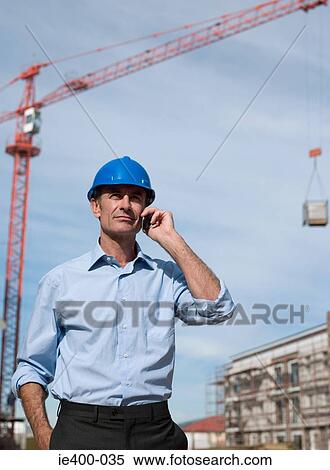 Engineer on cellphone View Large Photo Image Stock Photography - Engineer on cellphone. Fotosearch