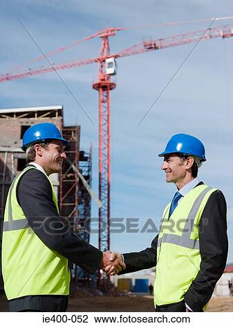 Engineers shaking hands View Large Photo Image Stock Image - Engineers shaking hands. Fotosearch