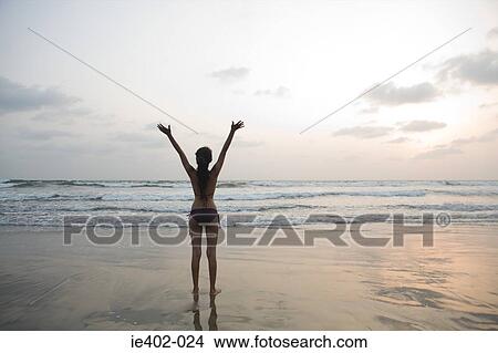 Picture - Young woman by the sea. Fotosearch