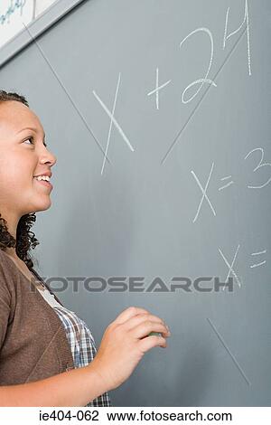 A student looking at a sum on a blackboard View Large Photo Image Stock Image - A student looking at a sum on a blackboard. Fotosearch