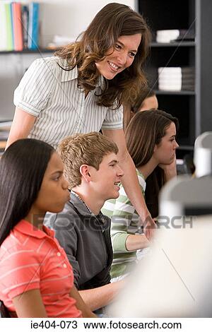 A teacher helping a student View Large Photo Image Stock Image - A teacher helping a student. Fotosearch