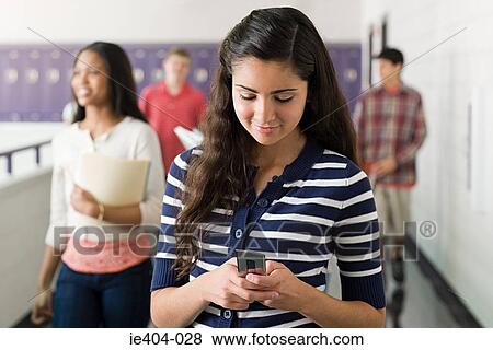 A teenage girl using a cell phone View Large Photo Image Stock Photo - A teenage girl using a cell phone. Fotosearch