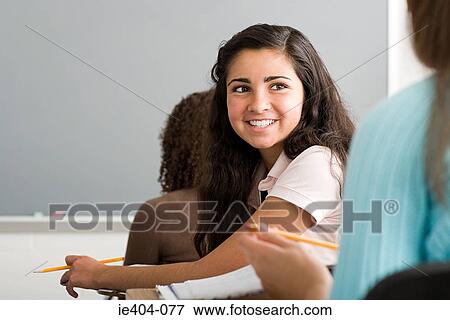 Girl smiling in class View Large Photo Image Stock Photo - Girl smiling in class. Fotosearch
