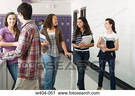 Stock Image - High school students walking down a corridor. Fotosearch