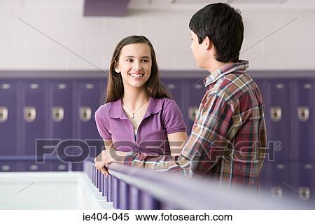 Teenage boy and girl talking in a corridor View Large Photo Image Stock Photography - Teenage boy and girl talking in a corridor. Fotosearch