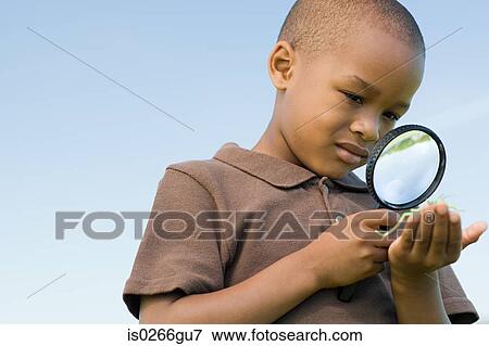 Stock Photo - Boy with a magnifying glass. Fotosearch