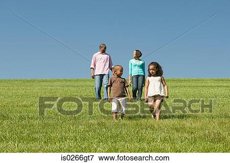 Family in a field View Large Photo Image Stock Photo - Family in a field. Fotosearch