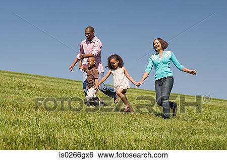 Family in a field View Large Photo Image Stock Photograph - Family in a field. Fotosearch