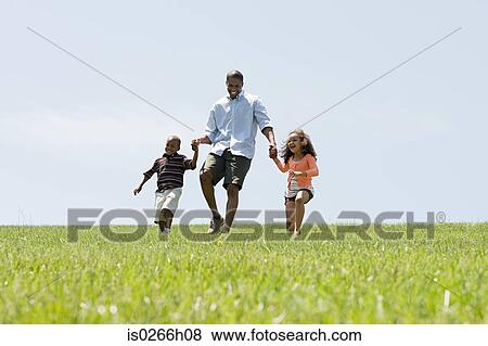 Father and children in field View Large Photo Image Stock Photo - Father and children in field. Fotosearch