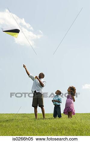 Father and children with kite View Large Photo Image Stock Photography - Father and children with kite. Fotosearch