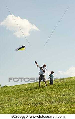 Father and son with kite View Large Photo Image Stock Image - Father and son with kite. Fotosearch