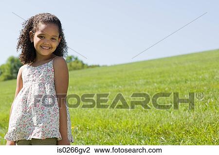 Girl in a field View Large Photo Image Stock Image - Girl in a field. Fotosearch