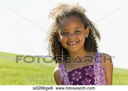 Girl in a field View Large Photo Image Stock Photograph - Girl in a field. Fotosearch