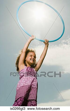 Girl with a plastic hoop View Large Photo Image Stock Image - Girl with a plastic hoop. Fotosearch